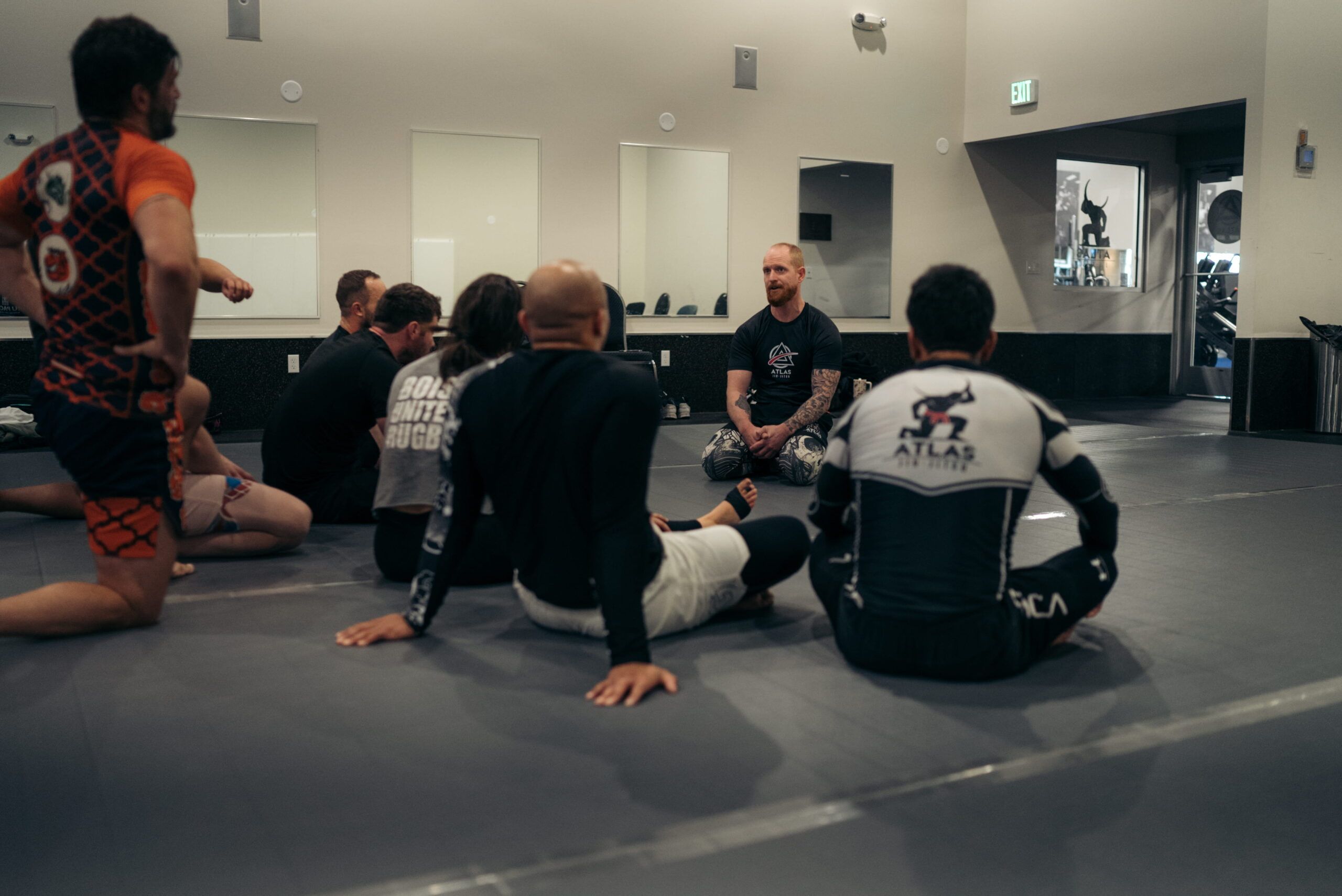 Atlas students seated on the mats during instruction